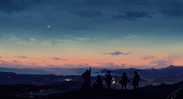 Silhouettes of people watching a sunset over a city