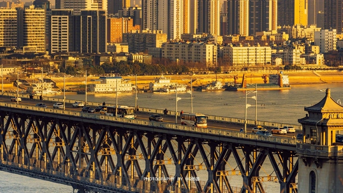 City skyline with a bridge and river at dusk
