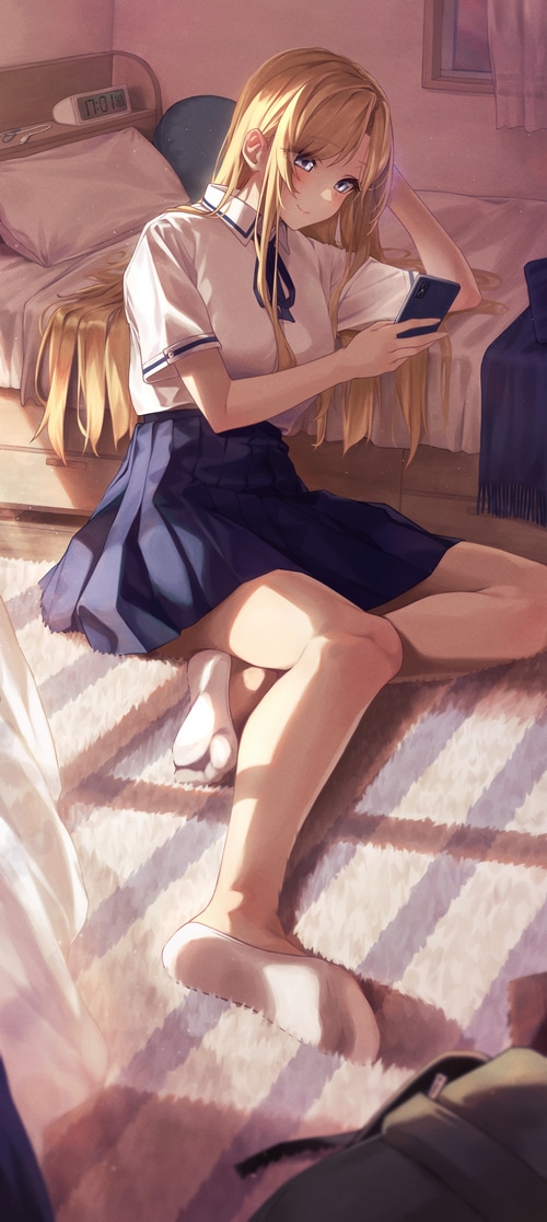 Schoolgirl in uniform with blonde hair using a smartphone
