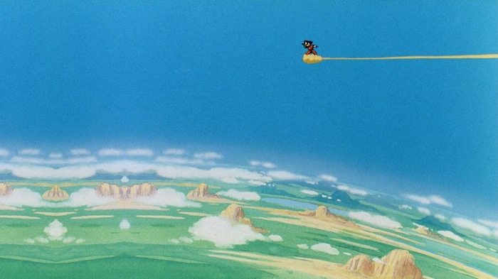 Son Goku rides the Flying Nimbus over a landscape