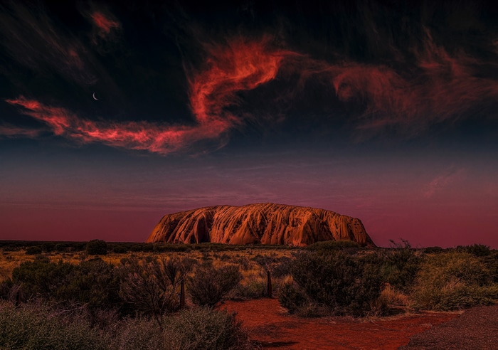 4K Uluru landscape at sunset with red clouds