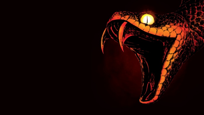 Close-up of a snake's head with fangs and glowing eyes