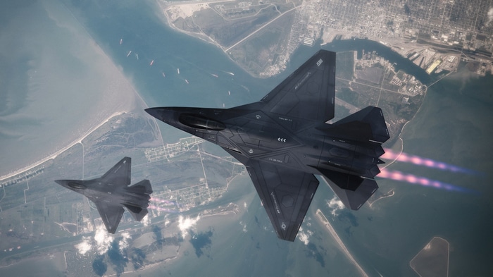 Two military aircraft flying over a coastal city