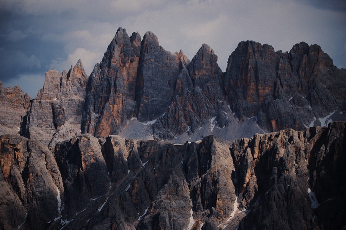 Jagged mountain peaks in the Alps under a cloudy sky