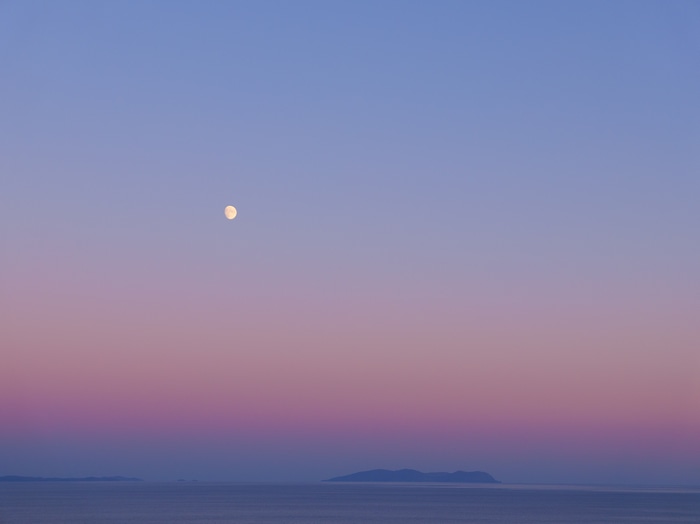 4K Moon over the ocean at twilight
