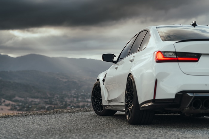 White BMW M3 G80 parked on a mountain road