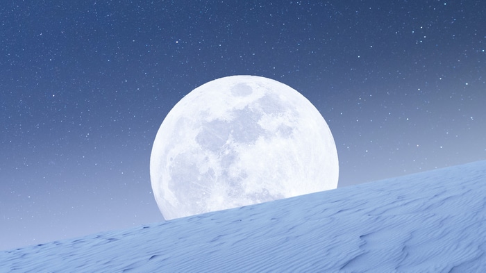 4K Moon and stars over a snowy landscape