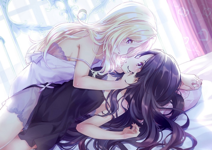 Two women in lingerie in bed