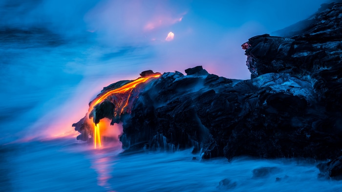 4K lava flowing into the ocean at dusk