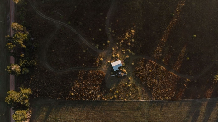 Aerial view of a small house in a rural landscape