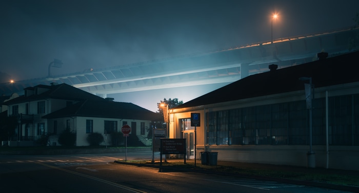 Night scene with bridge and buildings in mist