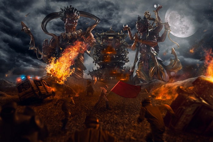 Giant figures and Chinese architecture with fire and ambulance