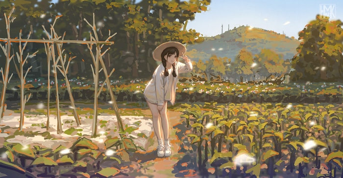 Girl in straw hat in a garden
