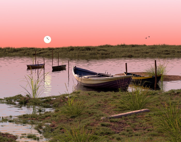 Boats on a calm river at sunset