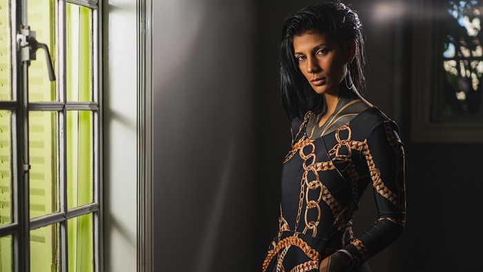 Woman with black hair wearing a patterned dress