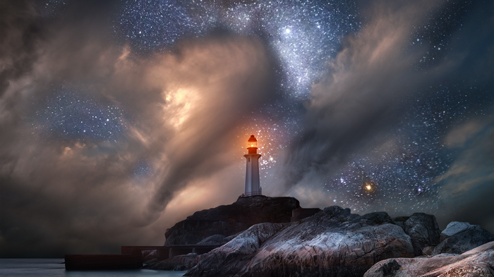 4K Lighthouse on Rocky Shore Under Starry Sky