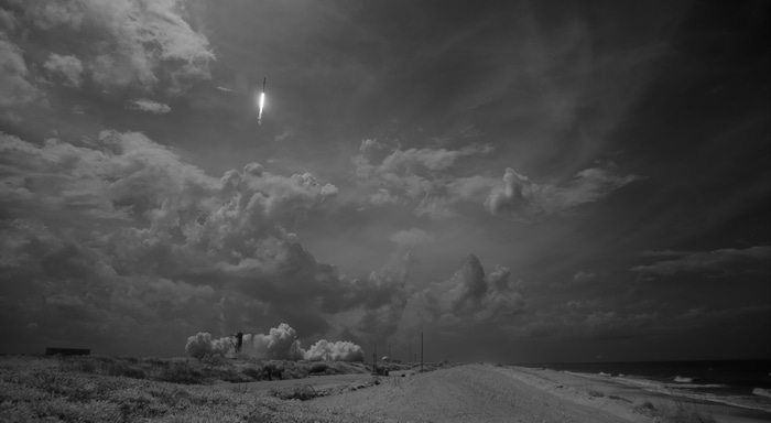 NASA rocket launching into cloudy sky