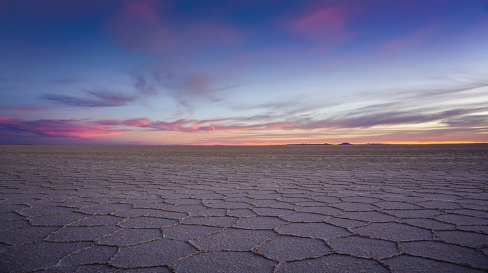 Salt lake landscape with colorful sunset clouds