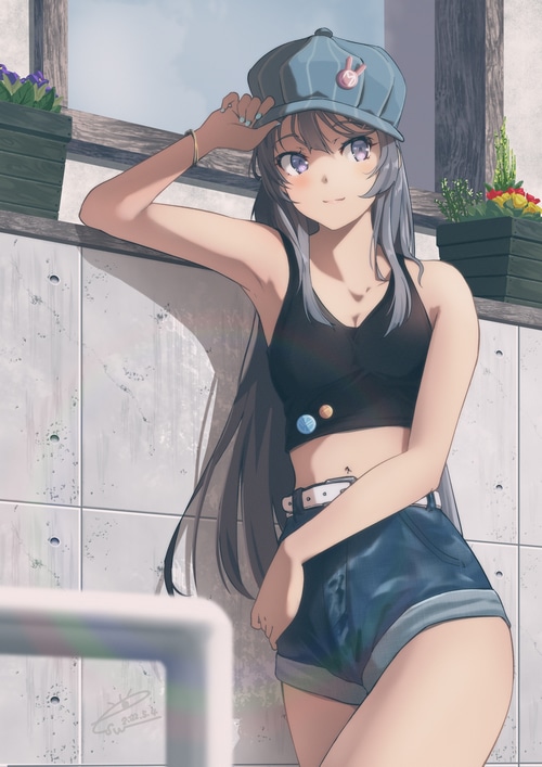 Girl in crop top and denim shorts wearing a cap