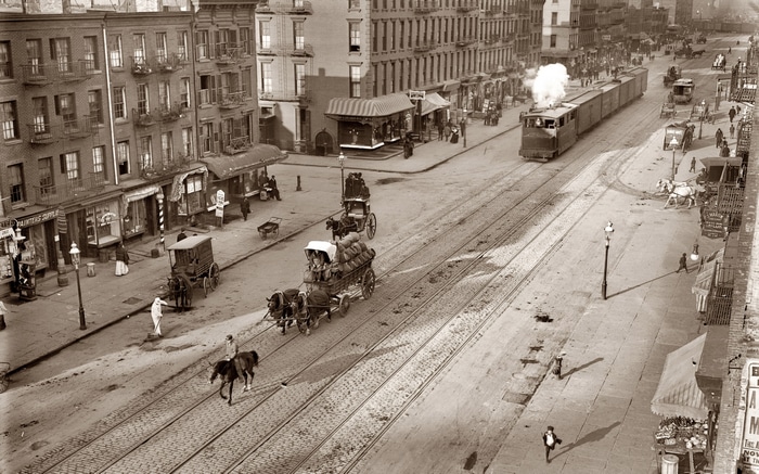 New York City street scene with horse-drawn carts and a tram