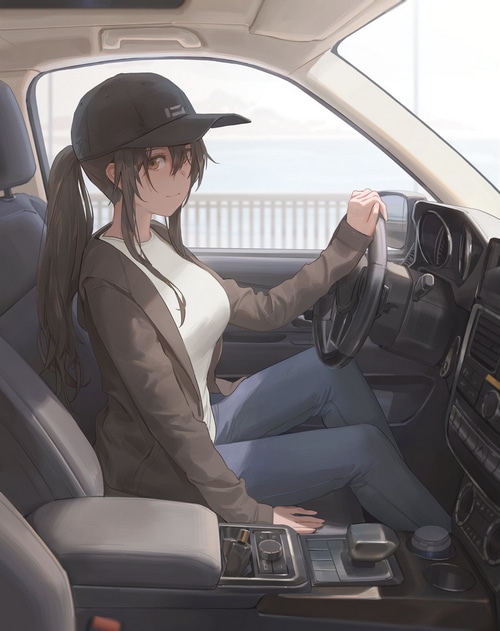 Woman wearing a baseball cap driving a car