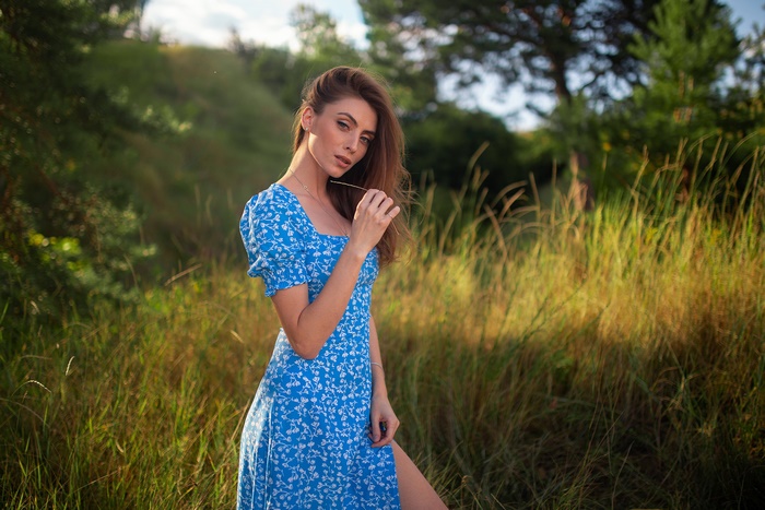 Woman in blue dress in a field