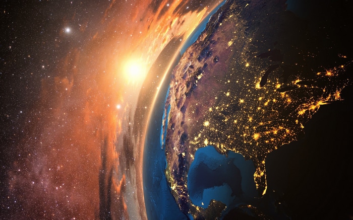 Earth from space with sun and stars