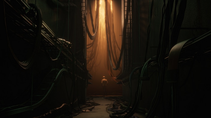 Man in a dimly lit server room with wires