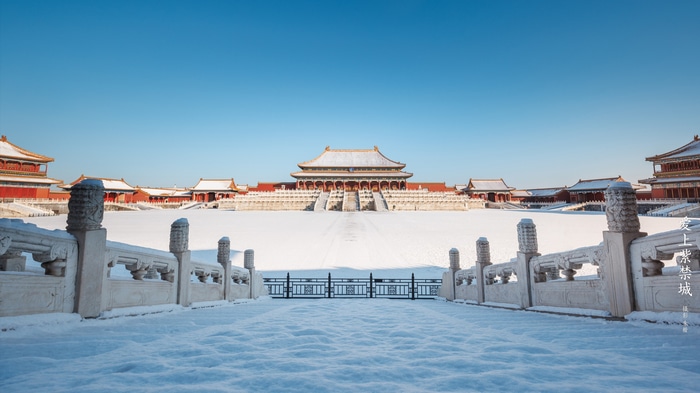 The Imperial Palace covered in snow under a clear blue sky