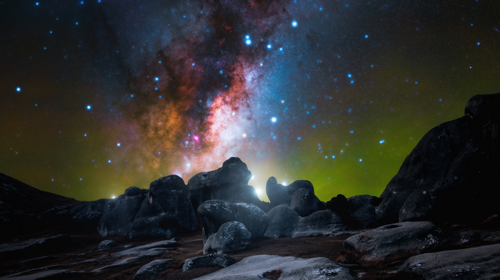 4K Galaxy Over Rocky Landscape at Night