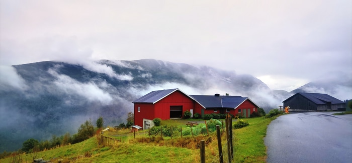4K Norway mountains landscape with houses and clouds