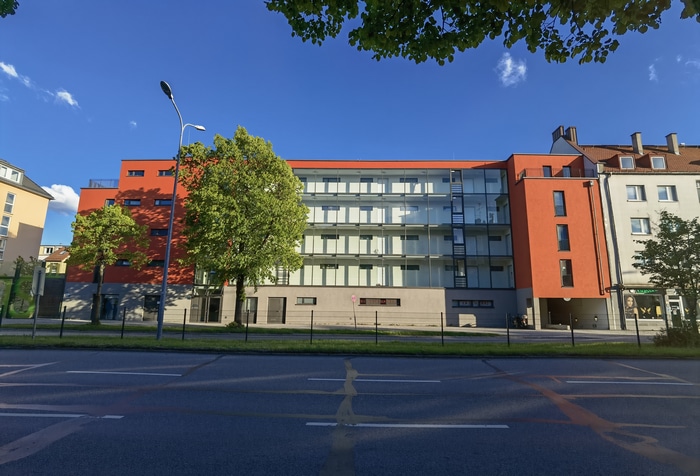 Modern building with glass facade and orange accents