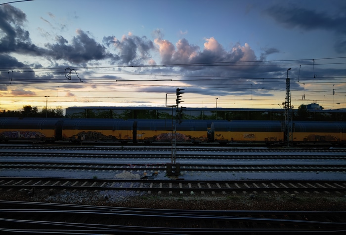 Railway tracks at sunset with clouds