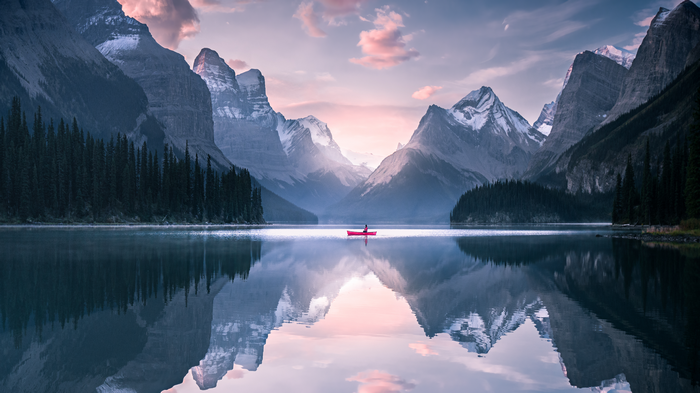 4K Canada landscape with a canoe on a lake and mountains
