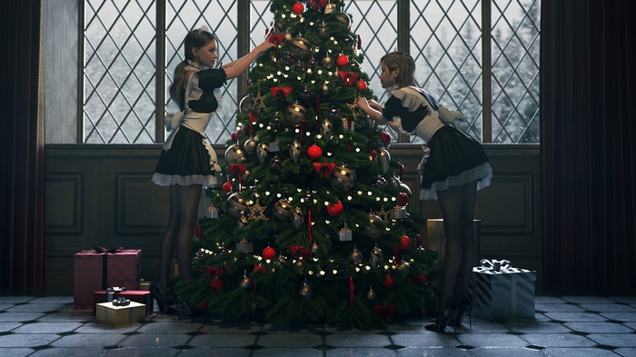 Two maids decorating a Christmas tree