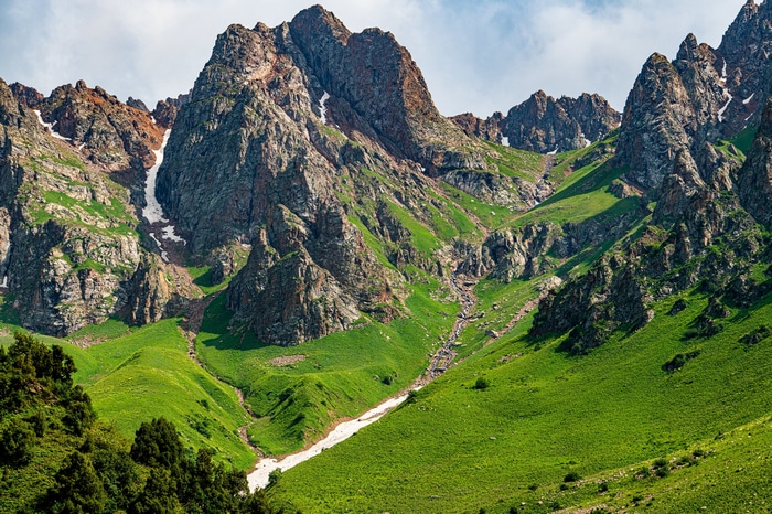 4K Mountain Landscape with Green Grass and Snow