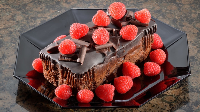 4K Chocolate Cake with Raspberries on Black Plate