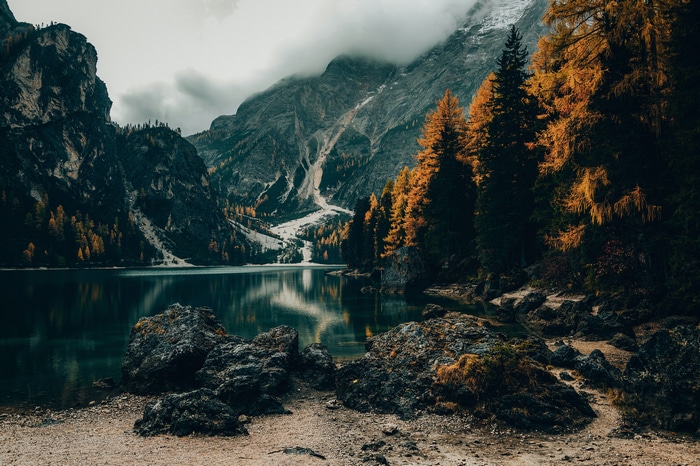 Autumn forest and mountains reflected in a lake