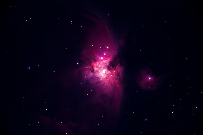 Pink and purple nebula with stars in space