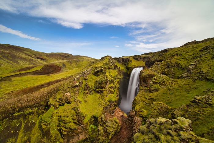 Waterfall in Iceland's green landscape