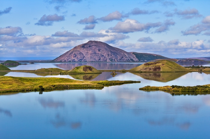 Lake landscape with islands and a mountain in Iceland