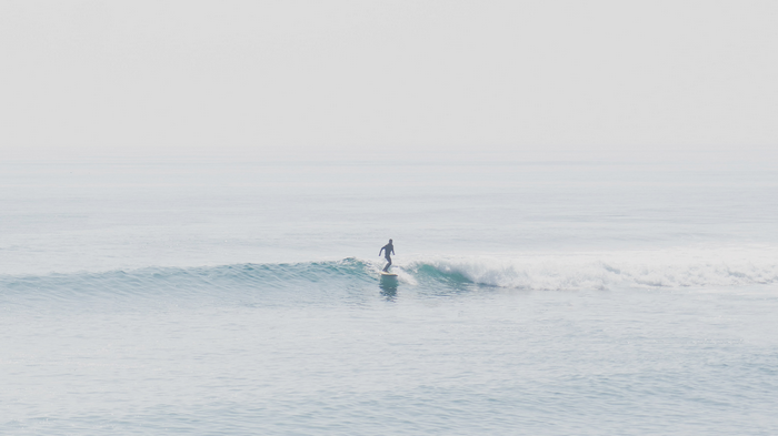 Surfer riding a wave in the ocean
