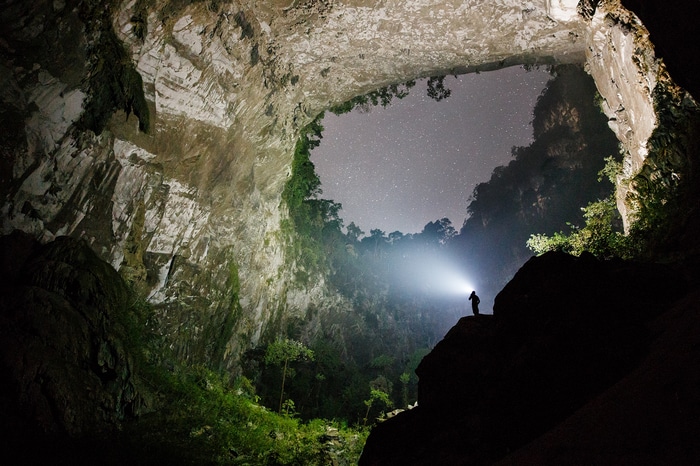 Person with flashlight in Hang Son Doong cave, Vietnam