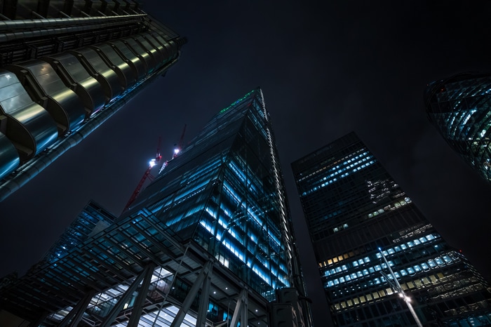 London skyscrapers at night with cranes