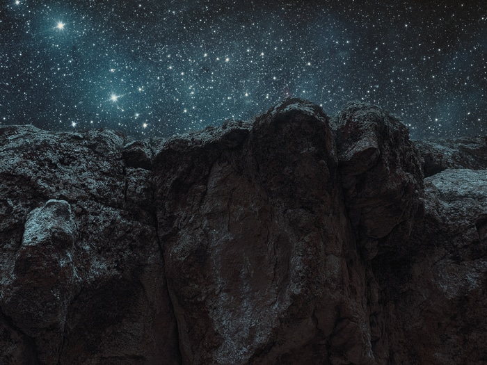 Rocky terrain under a starry night sky