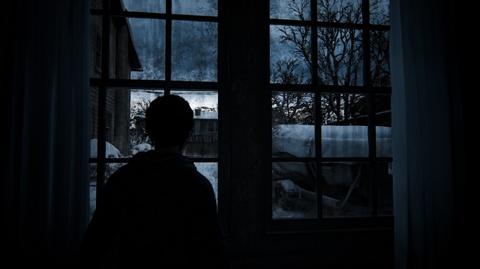 Ellie looks out a window in The Last of Us 2
