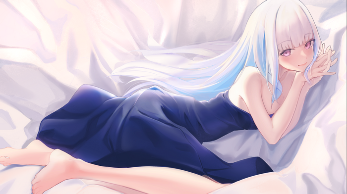Lize Helesta in a blue dress on a bed
