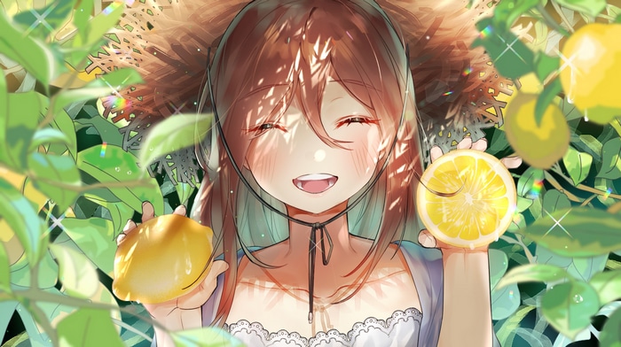 Girl in straw hat holding lemons