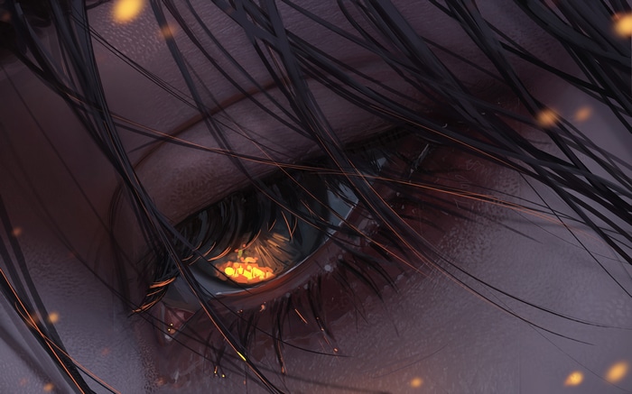 Close-up of an eye with reflections of fire