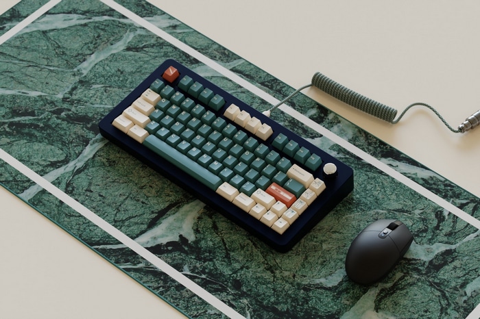 Mechanical keyboard and mouse on a marble deskmat